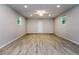 Spacious living room with plenty of natural light and modern light fixtures with wood-look flooring at 19266 Campground Rd, Brooksville, FL 34601