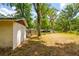 View of the shed on this sprawling property featuring a concrete exterior and well-manicured lawn at 19266 Campground Rd, Brooksville, FL 34601