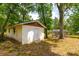 View of the shed on this sprawling property featuring a concrete exterior and well-manicured lawn at 19266 Campground Rd, Brooksville, FL 34601