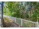 Peaceful backyard view with a white fence and lush greenery, offering privacy at 19528 Sunset Bay Dr, Land O Lakes, FL 34638