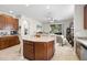 Kitchen with sleek counter tops and dark wood cabinets, flowing into an open-concept living space at 19528 Sunset Bay Dr, Land O Lakes, FL 34638