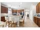 Spacious kitchen featuring an island with bar seating and dark wood cabinetry at 19528 Sunset Bay Dr, Land O Lakes, FL 34638