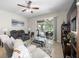 Cozy living room with a ceiling fan and sliding glass doors leading to outdoor living space at 19528 Sunset Bay Dr, Land O Lakes, FL 34638