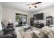 Comfortable living room with ceiling fan, access to outdoor patio area and stylish décor at 19528 Sunset Bay Dr, Land O Lakes, FL 34638