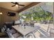 Outdoor living space with barbecue area, table, chairs, and screened enclosure for ultimate comfort at 19528 Sunset Bay Dr, Land O Lakes, FL 34638