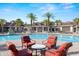 Community pool area with comfortable lounge chairs, a spacious pool, and palm trees at 19528 Sunset Bay Dr, Land O Lakes, FL 34638