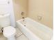 A bathroom featuring a tub with tile surround, a standard toilet and tile flooring at 2024 Blue Hawk Ct # 1822, Clearwater, FL 33762