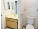 Bathroom with single sink vanity, toilet, a framed mirror and updated fixtures at 2024 Blue Hawk Ct # 1822, Clearwater, FL 33762