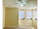 Bright bedroom with neutral walls, ceiling fan, and two windows providing natural light at 2024 Blue Hawk Ct # 1822, Clearwater, FL 33762