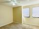 Neutral bedroom features two windows, ceiling fan and neutral carpet at 2024 Blue Hawk Ct # 1822, Clearwater, FL 33762