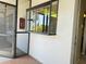 A screened entry providing access to a community room and the building's exterior at 2024 Blue Hawk Ct # 1822, Clearwater, FL 33762