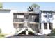 Two-story condo building with dual staircases leading to screened second-story porches at 2024 Blue Hawk Ct # 1822, Clearwater, FL 33762