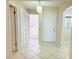 Bright foyer featuring modern chandelier, diamond-pattern tile flooring, and closet space at 2024 Blue Hawk Ct # 1822, Clearwater, FL 33762