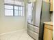 Kitchen featuring stainless steel refrigerator, window, and light wood cabinets at 2024 Blue Hawk Ct # 1822, Clearwater, FL 33762