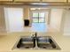 Kitchen with stainless steel sink overlooking the living room and fireplace at 2024 Blue Hawk Ct # 1822, Clearwater, FL 33762
