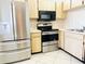 Kitchen with stainless steel appliances and light wood cabinets at 2024 Blue Hawk Ct # 1822, Clearwater, FL 33762