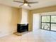 Bright living room featuring a cozy fireplace, tile flooring, and natural light at 2024 Blue Hawk Ct # 1822, Clearwater, FL 33762