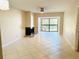 Spacious living room with tile floors, fireplace, ceiling fan, and sliding glass doors at 2024 Blue Hawk Ct # 1822, Clearwater, FL 33762
