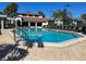 Community pool featuring lounge chairs, recreation center, and a tennis court perfect for relaxing and active living at 2024 Blue Hawk Ct # 1822, Clearwater, FL 33762