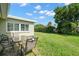 Expansive backyard with lush green lawn, ideal for outdoor dining and entertaining with patio furniture at 2060 Attache Ct, Clearwater, FL 33764