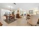 Open dining room featuring hardwood floors, chandelier, and a view into the living area at 2060 Attache Ct, Clearwater, FL 33764