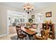 Dining room featuring a classic chandelier and views into the living room and kitchen at 2060 Attache Ct, Clearwater, FL 33764