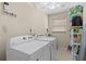 Functional laundry room with a washing machine, dryer, and ample storage space at 2060 Attache Ct, Clearwater, FL 33764
