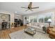Inviting living room features a neutral sofa, ceiling fan, and an adjacent office space at 2060 Attache Ct, Clearwater, FL 33764
