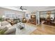 Open living room boasts a comfortable sofa, ceiling fan, and seamless flow into the dining area at 2060 Attache Ct, Clearwater, FL 33764