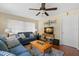 Cozy living room features a comfortable blue sofa, ceiling fan, and natural light from the window at 2060 Attache Ct, Clearwater, FL 33764
