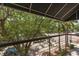 Balcony view featuring lush greenery, a canopy, and a view of the street below at 2253 Central Ave # 206, St Petersburg, FL 33713