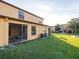 Exterior view of home with a grassy backyard and a screened in lanai for relaxing outdoors at 2453 Edgewater Falls Dr, Brandon, FL 33511