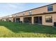 Back view of home with a grassy yard and a screened in porch for outdoor entertaining at 2453 Edgewater Falls Dr, Brandon, FL 33511