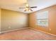 Bedroom featuring carpet, fan, and a large window at 2453 Edgewater Falls Dr, Brandon, FL 33511