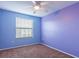 A secondary bedroom with carpeted floors, ceiling fan, and a window bringing in natural light at 2453 Edgewater Falls Dr, Brandon, FL 33511