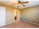 Bedroom features carpet, fan, and a doorway to ensuite bathroom at 2453 Edgewater Falls Dr, Brandon, FL 33511