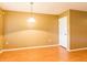 Cozy dining room with wood floors, a simple light fixture, and neutral walls offers a warm ambiance at 2453 Edgewater Falls Dr, Brandon, FL 33511