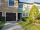 This shows a townhome featuring a single-car garage, manicured lawn, and welcoming front entryway at 2453 Edgewater Falls Dr, Brandon, FL 33511