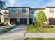 Charming townhomes with attached garages, landscaped front yards, and walkways leading to the front doors at 2453 Edgewater Falls Dr, Brandon, FL 33511