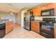 A view of the kitchen with stainless steel appliances and wooden cabinets at 2453 Edgewater Falls Dr, Brandon, FL 33511