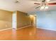 Living room features hardwood flooring, fan, and light blue accent wall at 2453 Edgewater Falls Dr, Brandon, FL 33511