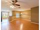 Open-concept living area with hardwood floors and a ceiling fan, ideal for flexible living and entertaining at 2453 Edgewater Falls Dr, Brandon, FL 33511