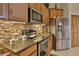 Modern kitchen featuring stainless steel appliances and granite countertops at 2642 Meadow Wood Dr, Clearwater, FL 33761