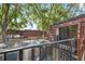 A cozy balcony featuring a screen enclosure and stunning views of lush trees and neighboring buildings with terracotta tiled roofs at 2722 11Th Ct # 50A, Palm Harbor, FL 34684