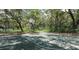 Outdoor basketball court surrounded by trees providing a shaded space for recreation at 2722 11Th Ct # 50A, Palm Harbor, FL 34684