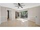 Spacious bedroom with tile floors, ceiling fan, and sliding glass doors offering natural light and balcony access at 2722 11Th Ct # 50A, Palm Harbor, FL 34684