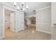 Open dining area with tile floors, chandelier, and easy access to the living room and stairway at 2722 11Th Ct # 50A, Palm Harbor, FL 34684