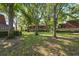 A well-maintained lawn and mature trees surround the brick townhouses of this charming community at 2722 11Th Ct # 50A, Palm Harbor, FL 34684