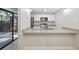 Bright kitchen with white cabinets, stainless steel appliances, granite countertops, and a convenient breakfast bar at 2722 11Th Ct # 50A, Palm Harbor, FL 34684