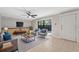 Bright living room with tile floors, ceiling fan, modern furniture, and sliding doors to the screened lanai at 2722 11Th Ct # 50A, Palm Harbor, FL 34684